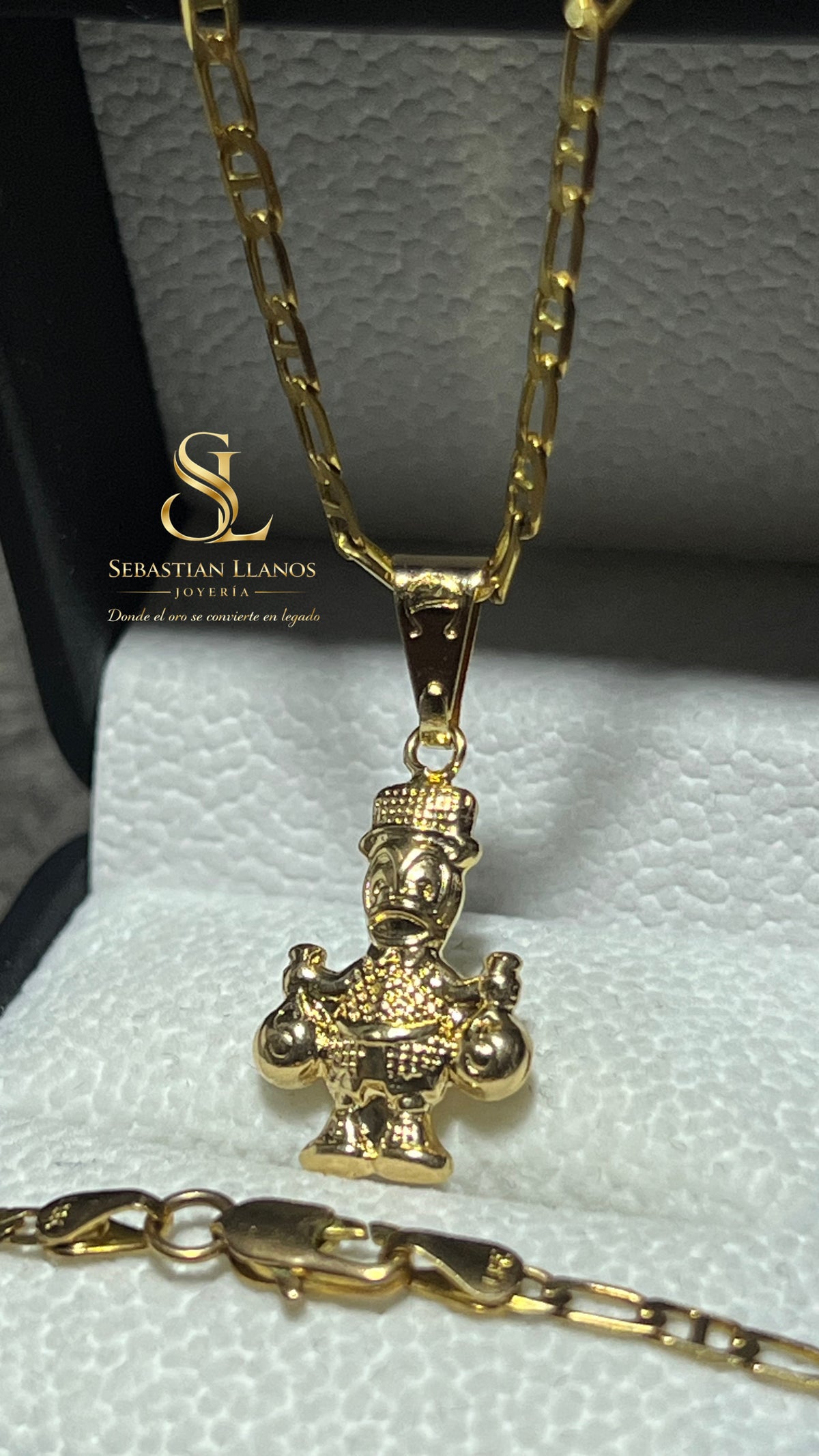 Dije tío rico dorado doble bolsa